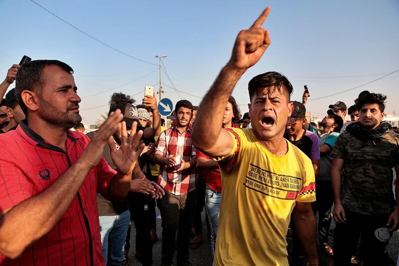 Protesters chant anti-government slogans during a demonstration demanding better public services and jobs, and the end to corruption in Basra, southeast of Baghdad, Iraq.  AP