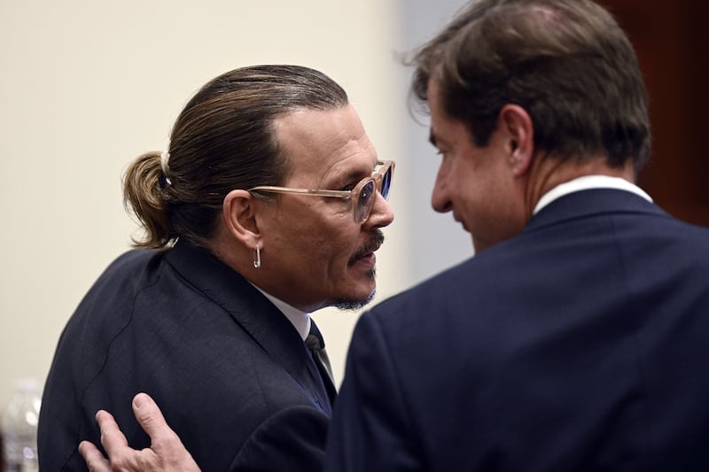 Depp talks to his lawyer during the trial at the Fairfax County Circuit Court in Virginia. AP