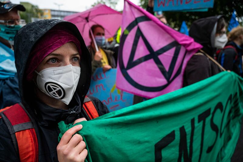 Demonstrators affiliated with Extinction Rebellion hold up banners as they march in front of the Social Democratic Party of Germany headquarters in Berlin. AFP