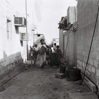 Drummer Khamees Abu Tubaila and his entourage walk the alleyways of Abu Dhabi to wake people and prepare them for the day’s fasting. Photo: Alettihad