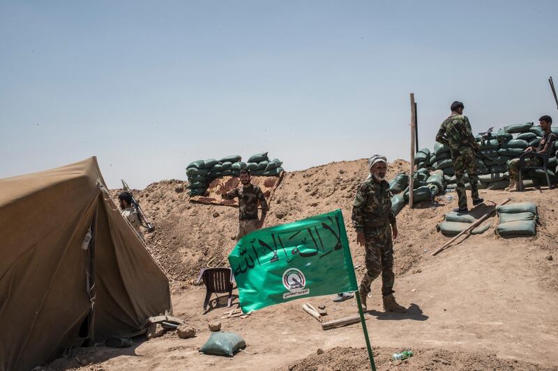 NINEVEH, IRAQ - JUNE 20: Iraqi PMF fighters at their position June 20, 2017 on the Iraq-Syria border in Nineveh, Iraq. The Popular Mobilisation Front (PMF) forces, composed of majority Shi'ite militia, part of the Iraqi forces, have pushed Islamic State militants from the north-western Iraq border strip back into Syria. The PMF now hold the border, crucial to the fall of Islamic State in Mosul, blocking the Islamic State supply route for militants from Syria to Mosul. (Martyn Aim/Getty Images).