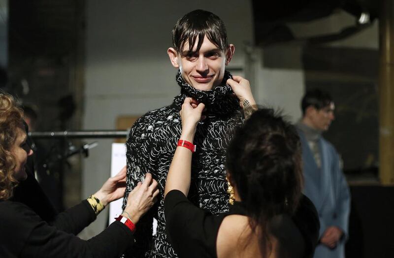 More than 130 designers showed off their wares at London’s men’s fashion week to international press and buyers from 37 countries. Above, assistants dress a model backstage during the event. Suzanne Plunkett / Reuters