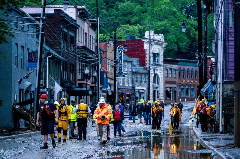 Rescue personnel examine damage on Main Street after a flash flood rushed through the historic town of Ellicott City, Maryland, USA, 27 May 2018. The National Weather Service stated as much as 9.5 inches of rain fell in the area.  Jim Lo Scalzo / EPA