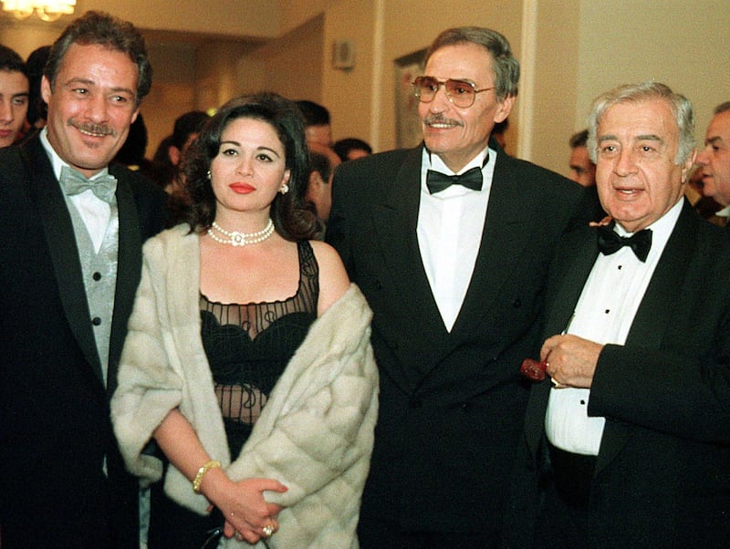 (L to R) Egyptian film stars Faruq al-Fishawi, Elham Shahine, Ezzat al-Alaili and Syrian mega-film producer Mustafa Al-Aqqad attend the awards ceremony at the 23rd Cairo international film festival 04 December 1999. (Photo by MOHAMMED AL-SEHITI / AFP)