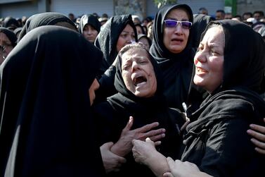 Families of victims of Saturday's terror attack on a military parade in the Iranian city of Ahvaz in September last year. AP