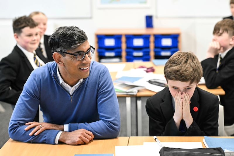 Mr Sunak meets pupils in a maths class during a visit to the John Whitgift Academy, in Grimsby. AP