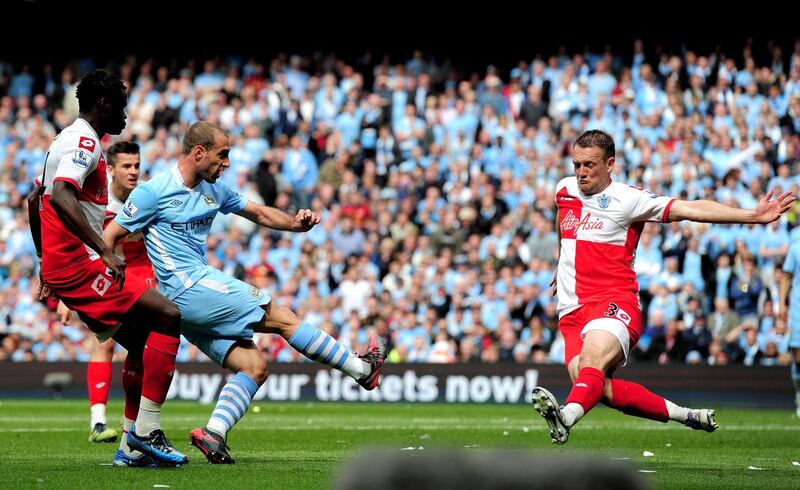 MANCHESTER, ENGLAND - MAY 13:  Pablo Zabaleta of Manchester City scores the opening goal past the outstretched Clint Hill of QPR during the Barclays Premier League match between Manchester City and Queens Park Rangers at the Etihad Stadium on May 13, 2012 in Manchester, England.  (Photo by Shaun Botterill/Getty Images)