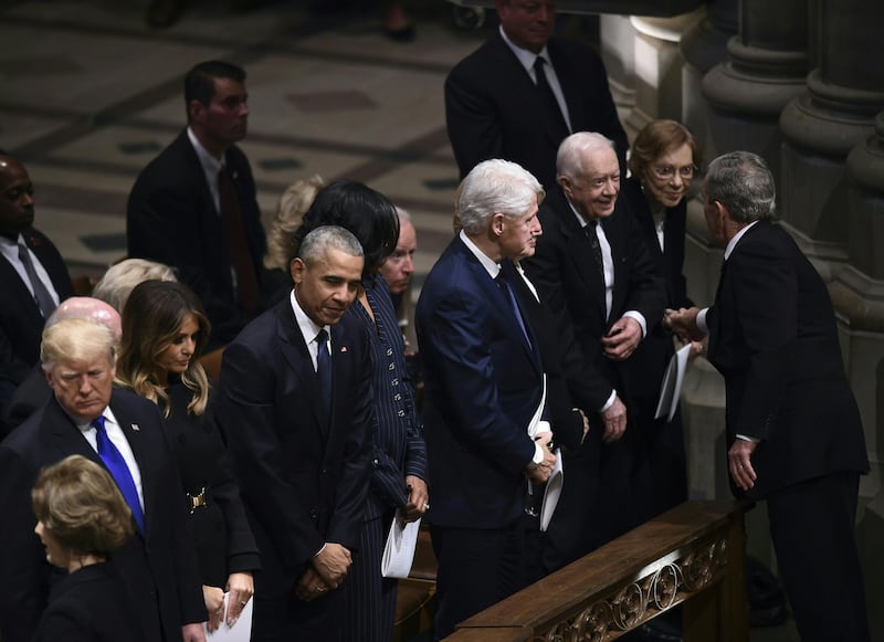 Former president George W. Bush, top right, greets (from left) US president Bill Clinton and Hillary Clinton, and former president Jimmy Carter and Rosalynn Carter during the funeral service for his father. AFP