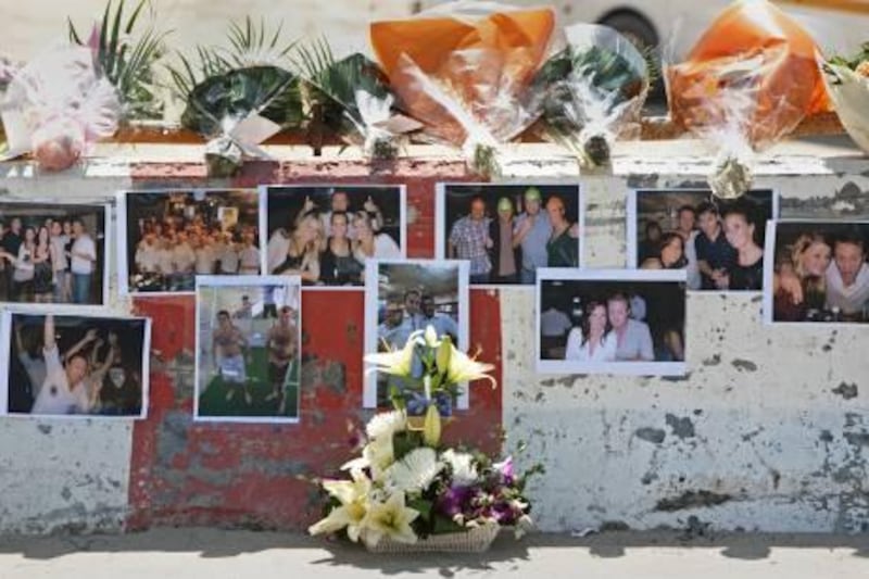 Dubai, March 21, 2011 - Friends have placed pictures and flowers on a barricade on the bridge that Elliot Lintott, 27, of Britain, fell off of and died early on March 19 in the Dubai Marina area in Dubai March 21, 2011. (Jeff Topping/The National)