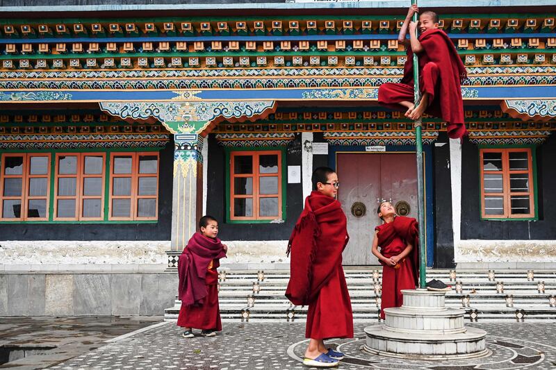 Young Buddhist monks play between prayers at the Tawang monastery in the north-east Indian state of Arunachal Pradesh. AFP