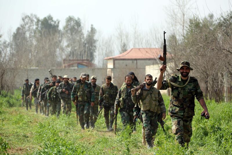 Syrian regime forces are pictured in the town of Aftris, west of the rebel-held town of Saqba, in the besieged Eastern Ghouta region on the outskirts of the capital Damascus, on March 10, 2018. AFP