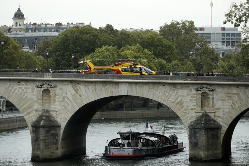 An emergency rescue services helicopter stands on a bridge. EPA