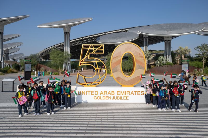 Children posing for a group photo in front of the UAE's Golden Jubilee installation at the Earth Plaza. Image: Expo 2020 Dubai
