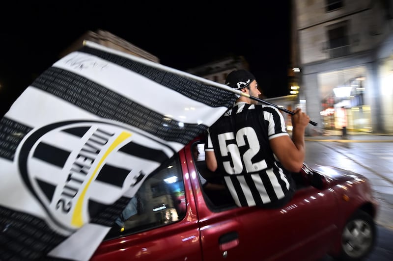 Juventus fans celebrate winning Serie A in Turin. Reuters