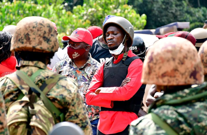 Bobi Wine is escorted by policemen during his arrest in Kalangala in central Uganda on December 30, 2020. Reuters