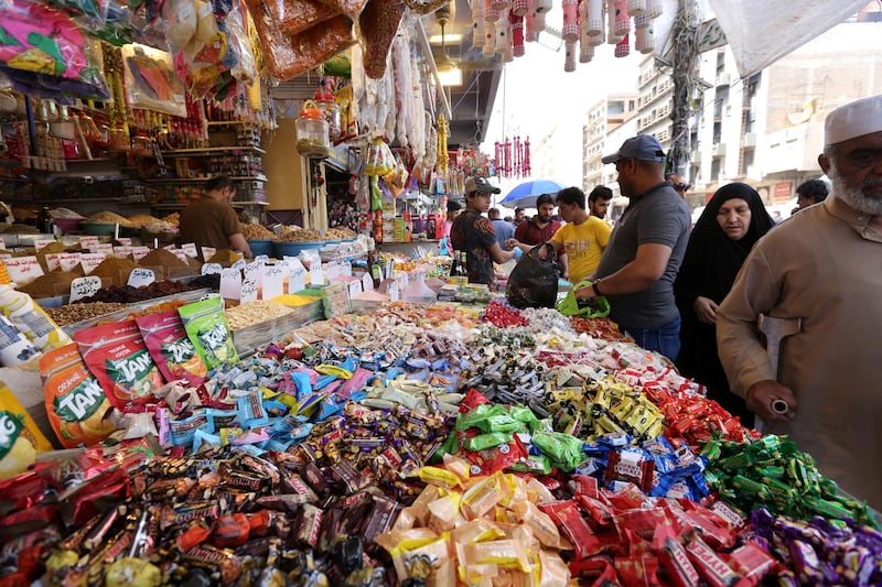 Iraqis buy sweets ahead of the first day of the holy month in central Baghdad.  EPA