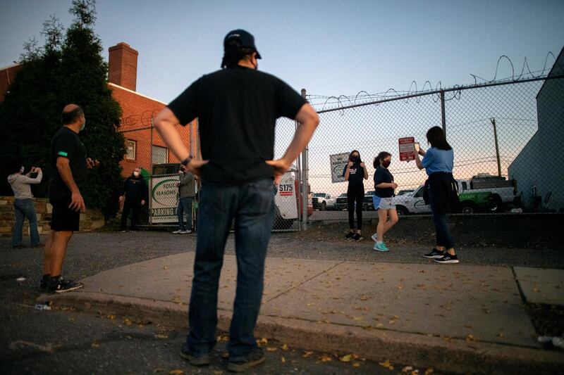 Abby Webber photographs her daughter Tara, 18, outside Four Seasons Landscaping. Reuters