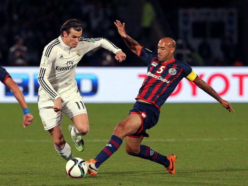 Real Madrid’s Gareth Bale (L) vies for the ball with San Lorenzo’s Juan Mercier  (R) during the final match of the FIFA Club World Cup 2014 between San Lorenzo of Argentina and Real Madrid of Spain, in Marrakech, Morocco, 20 December 2014. EPA/KHALED ELFIQI