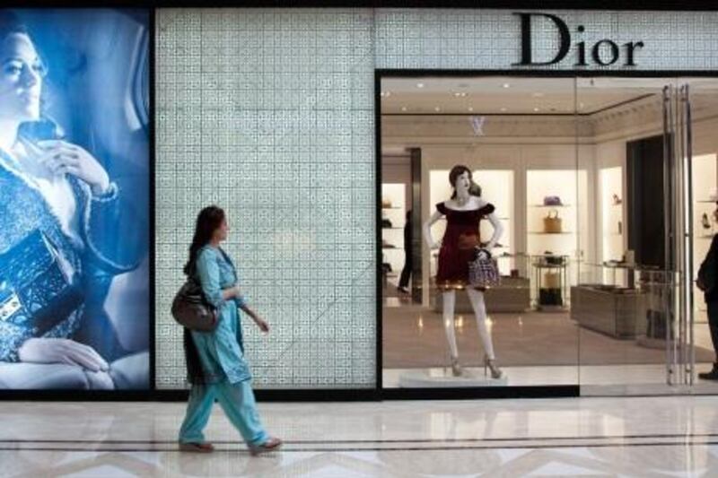 A woman walks past a Christian Dior SA store at the DLF Emporio shopping mall in New Delhi, India, on Thursday, Sept. 29, 2011. India's economy will grow 7.8 percent in 2011, the International Monetary Fund said in its World Economic Outlook on Sept. 20, slower than the 8.2 percent estimated in June. Photographer: Graham Crouch/Bloomberg