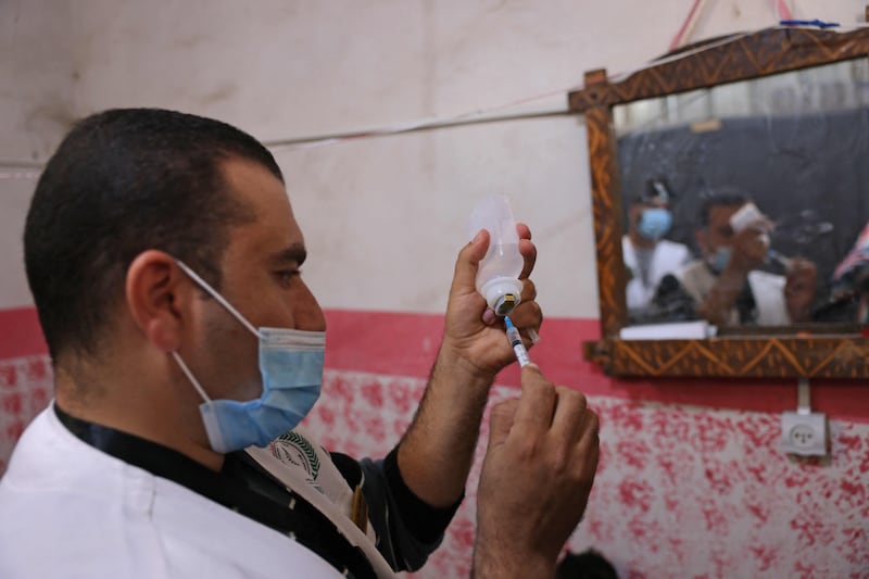 A medic prepares a Covid-19 vaccine dose during an inoculation campaign in the Palestinian city of Rafah. AFP