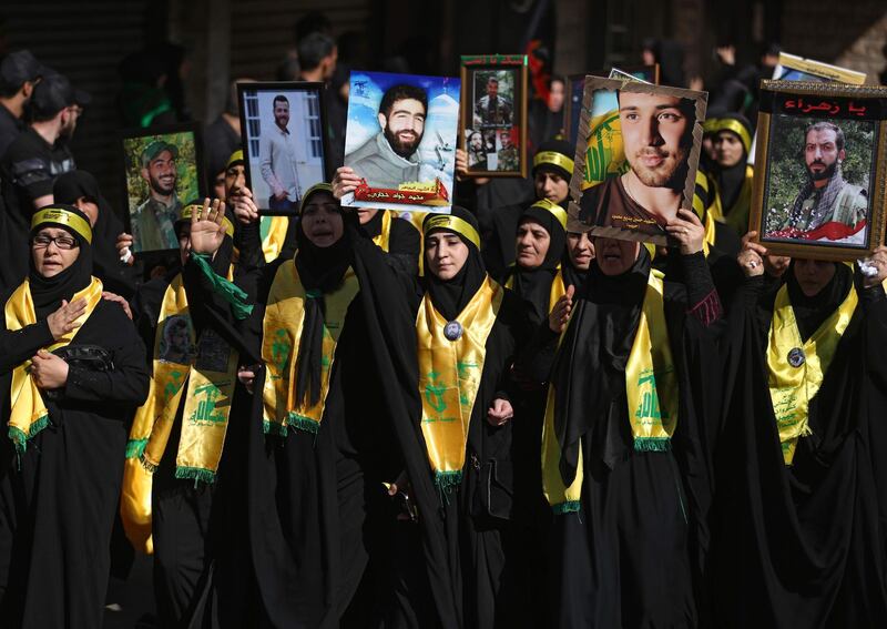 Lebanese Muslim Shiite women affliated to Hezbollah march holding pictures of their relatives killed in Syria as they mark Ashura in a southern suburb of Beirut on October 1, 2017.
The religious festival of Ashura, which includes a ten-day mourning period, commemorates the seventh century slaying of Prophet Mohammed's grandson Imam Hussein in Karbala in Iraq. / AFP PHOTO / PATRICK BAZ