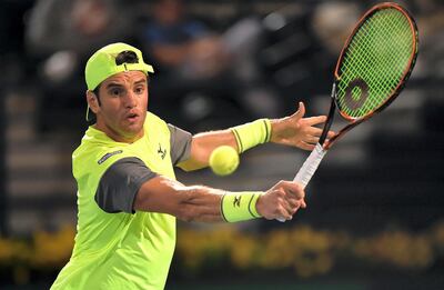 DUBAI, UNITED ARAB EMIRATES - FEBRUARY 27:  Malek Jaziri of Tunisia plays a backhand against Grigor Dimitrov of Bulgaria on day two of the ATP Dubai Duty Free Tennis Championships at the Dubai Duty Free Stadium on February 27, 2018 in Dubai, United Arab Emirates.  (Photo by Tom Dulat/Getty Images)