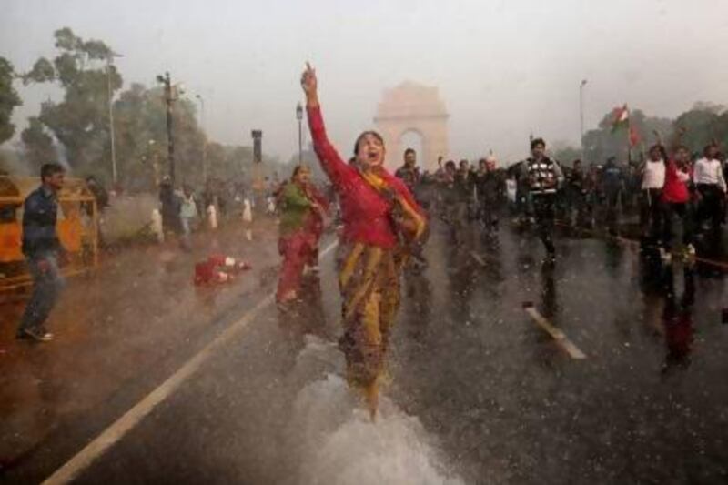 Police spray a female protester with a water cannon during a violent demonstration near the Gateway to India against a gang rape and brutal beating of a 23-year-old student in New Delhi.