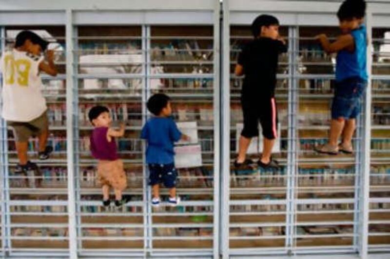 Children of foreign workers climb on a metal bookcase in Tel Aviv. As many as 1,200 children of such workers are at risk of deportation.