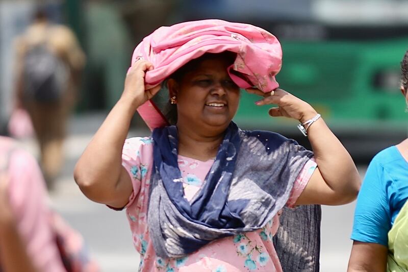 A woman shields herself from the sun during a heatwave in Bangalore, India, in April. EPA