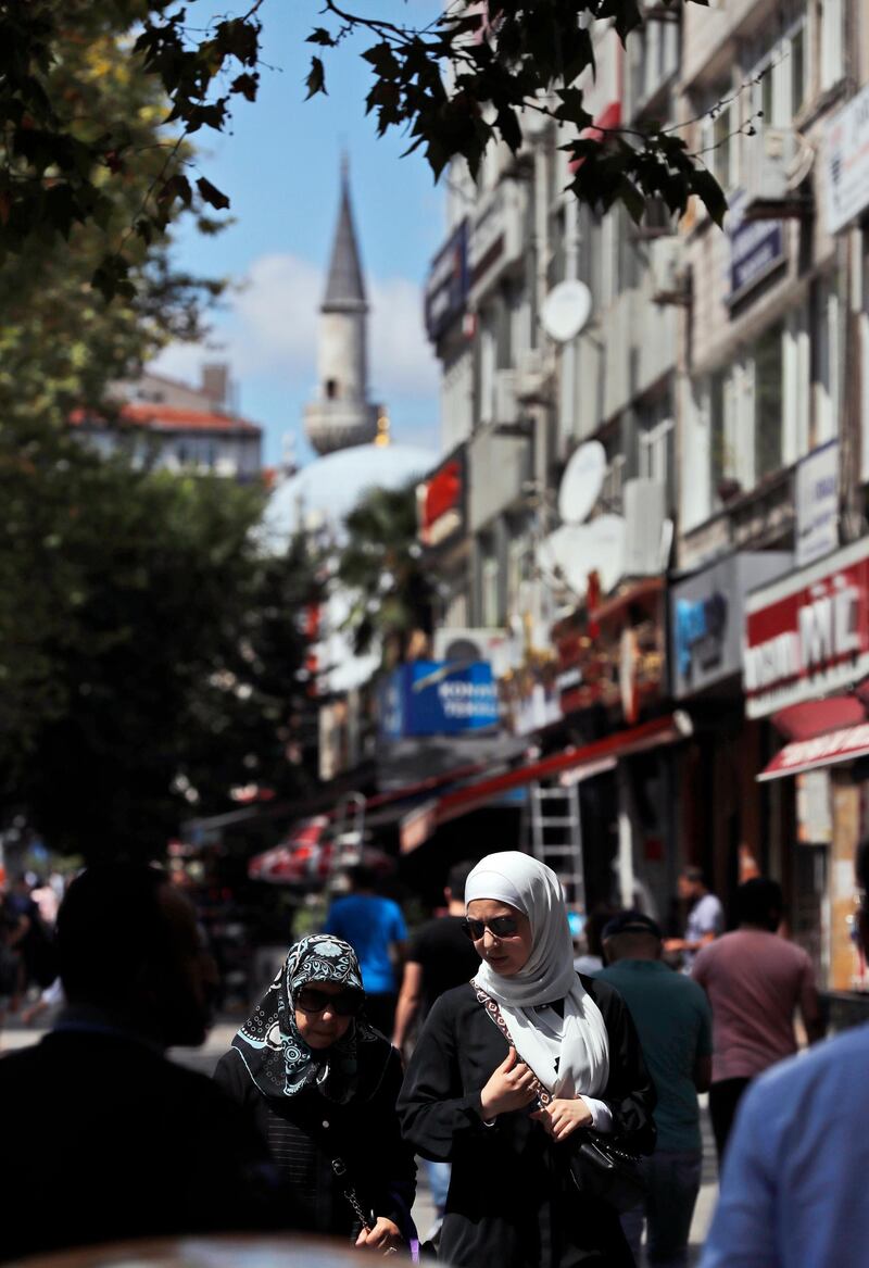 People walk in the Istanbul neighborhood of Aksaray, where many Syrians live. Syrians say Turkey has been detaining and forcing some Syrian refugees to return back to their country the past month. The expulsions reflect increasing anti-refugee sentiment in Turkey, which opened its doors to millions of Syrians fleeing their country's civil war. AP Photo