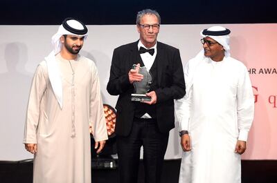 Film director Mohammad Bakri C) receives a price from Sheikh Hamdan bin Mohammed bin Rashid al-Maktoum (L) and and from the director of the Dubai International Film Festival (DIFF), Masoud Amralla Al Ali (R), during the closing ceremony of the Dubai International Film Festival in Dubai on December 13, 2017. (Photo by Ammar Abd Rabbo / DIFF / AFP) / RESTRICTED TO EDITORIAL USE - MANDATORY CREDIT "AFP PHOTO / DIFF  /Ammar Abd RABBO - NO MARKETING NO ADVERTISING CAMPAIGNS - DISTRIBUTED AS A SERVICE TO CLIENTS -
