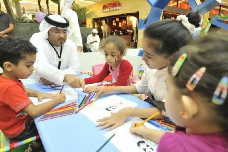 Volunteer Amer Al Za’abi at the Dubai Foundation for Women and Children’s “Childhood Carnival” in Dubai, yesterday. The event mixed fun with a serious message about child abuse. Charles Crowell for The National