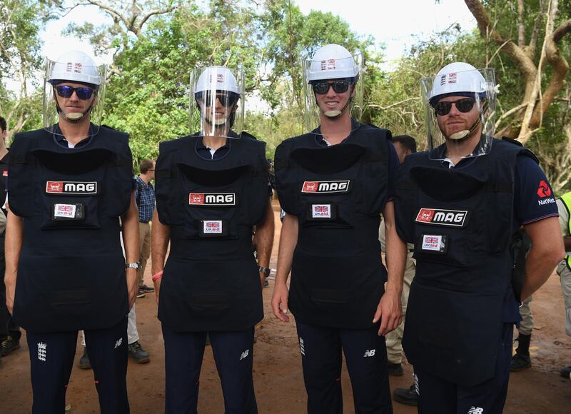 England players, left to right, Olly Stone, Joe Root, Keaton Jennings and Jonny Bairstow fitted out with de-mining personal protective equipment pictured before a tour of a previously cleared area of mine site during the England cricket team's visit to a de-mining event. Getty Images