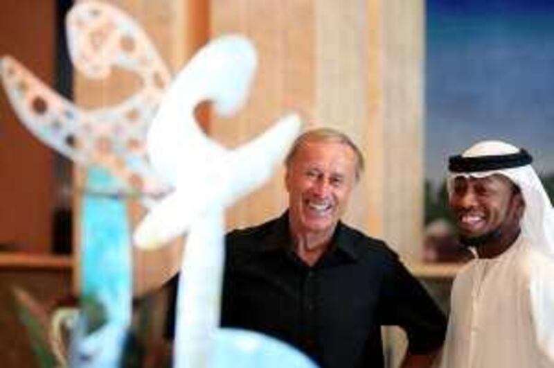 September 24, 2009 / Abu Dhabi / (Rich-Joseph Facun / The National) From left, Josef Hickersberger (CQ), Head Coach of Al-Wahda FC, and Ismael Matar (CQ), right, stand near a sculpture made by young UAE nationals during a promotional event for the Royal Euro 2008 Football Charity, Thursday, September 24, 2009 in Abu Dhabi.  *** Local Caption ***  rjf-0924-football003.jpg
