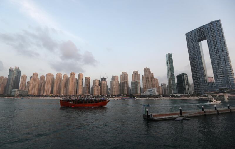 epa08956097 People enjoy the nice weather on a tourist boat during sunset in Gulf Emirate of Dubai, United Arab Emirates, 21 January 2021.  EPA/ALI HAIDER