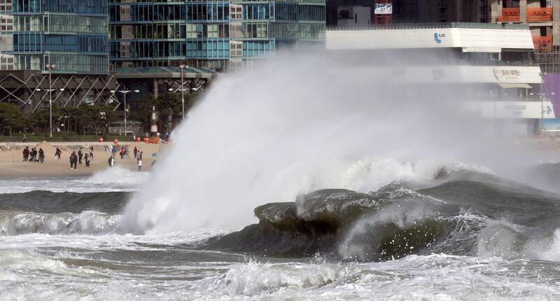 Tall waves strike a beach in Busan, 453 kilometres southeast of Seoul, South Korea, as Typhoon Lan approaches the area. Yonhap / EPA