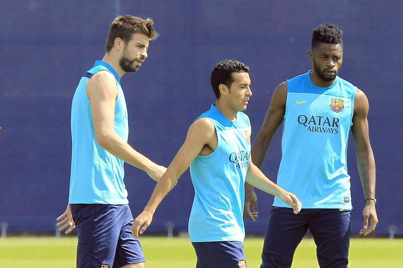 Barcelona players Gerard Pique, Pedro Rodriguez and Alex Song during the club's training session for their Atletico Madrid contest. Andreu Dalmau / EPA / May 16, 2014
