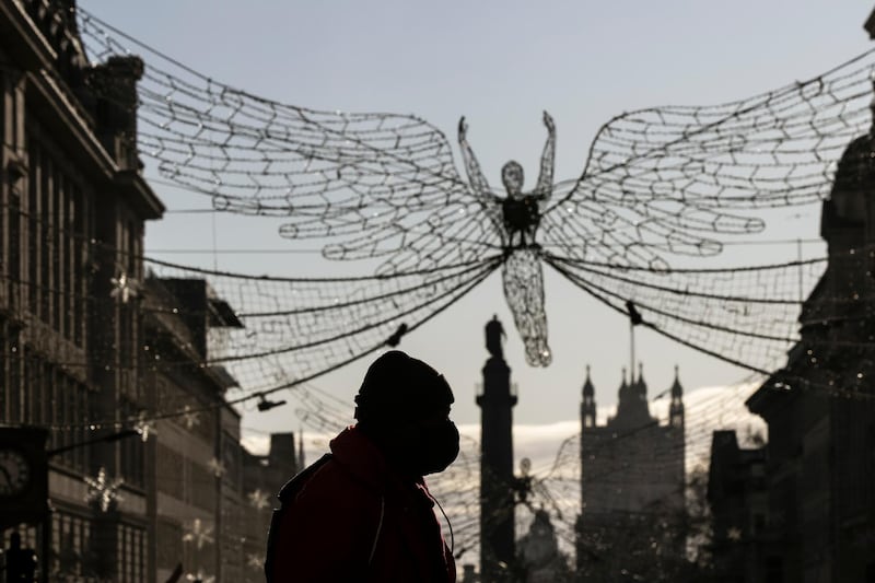 A member of the public walks across Piccadilly Circus in London. Getty Images