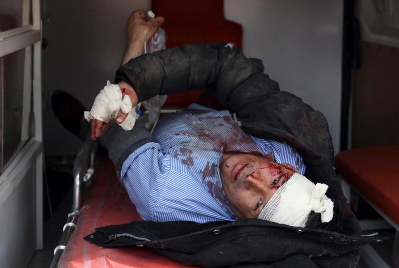 An injured man looks out from an ambulance after a suicide attack in Kabul. Rahmat Gul / AP Photo