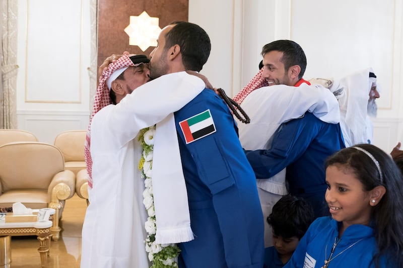 ABU DHABI, UNITED ARAB EMIRATES - October 12, 2019: The Father of Hazza Ali Al Mansoori, the first UAE Astronaut to be deployed on a space mission to the International Space Station (ISS) (R) greets his son during a homecoming reception at the Presidential Airport. Seen with Sultan Saif Al Neyadi, a member of the International Space Station (ISS) mission back-up team (L).


( Mohamed Al Hammadi / Ministry of Presidential Affairs )
---