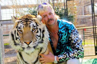 Joseph Maldonado-Passage, also known as Joe Exotic, poses with one of his tigers. AFP / Netflix