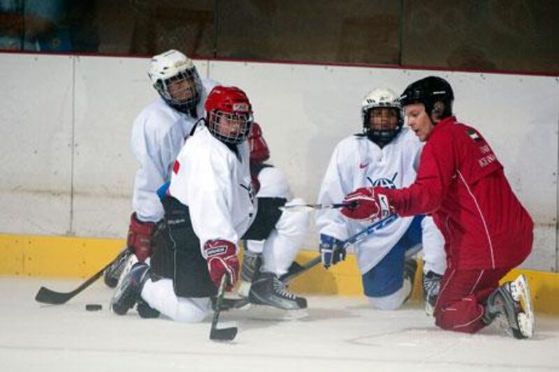 Matti Fagerstrom, in red, is coaching players at grass-roots level, including in the Under 20 Emirates Hockey League.