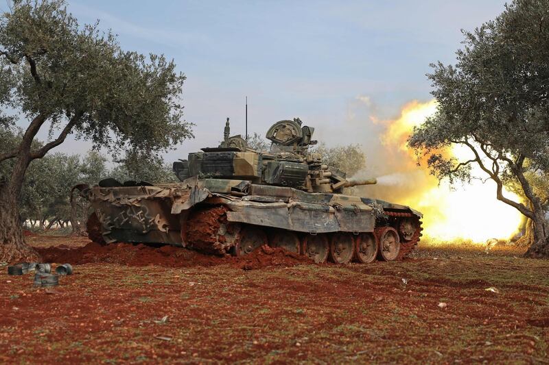 Syrian rebel fighters fire towards government forces from their position in the Idlib countryside.AFP