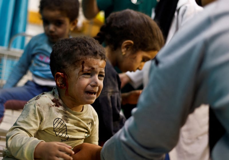 Palestinian children wounded in Israeli strikes amid the  Israel-Gaza war wait for treatment at Nasser Hospital. Reuters