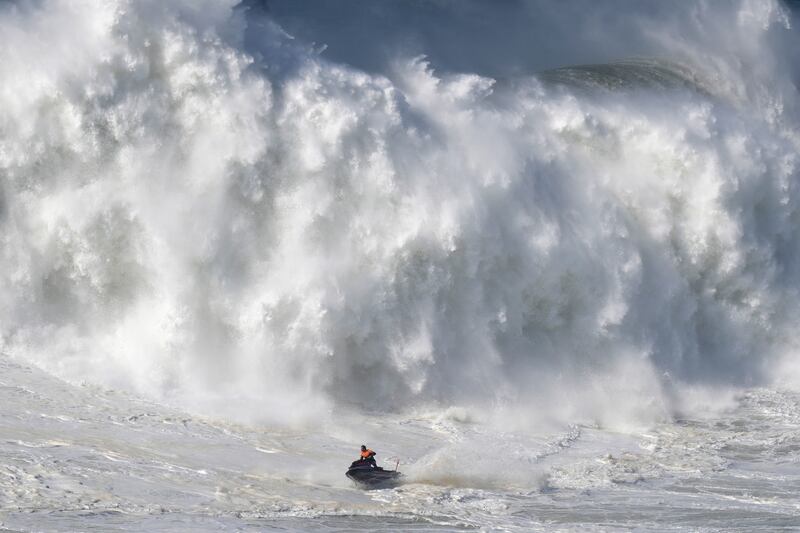 A jet ski steers away from a crashing wave during a big wave surfing session at Praia do Norte, or North Beach, in Nazare, Portugal. AP Photo