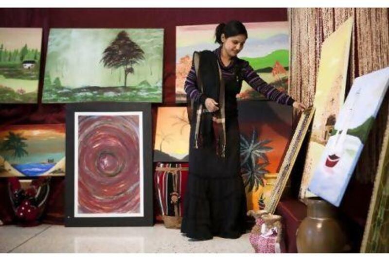 Rosalina Godoy teaches fine art at UAE University. At her booth are paintings by mentally or physically disabled artists. Lee Hoagland / The National