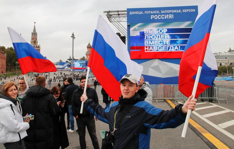 People gather in front of screens located near the Kremlin before the live broadcast of the ceremony. Reuters