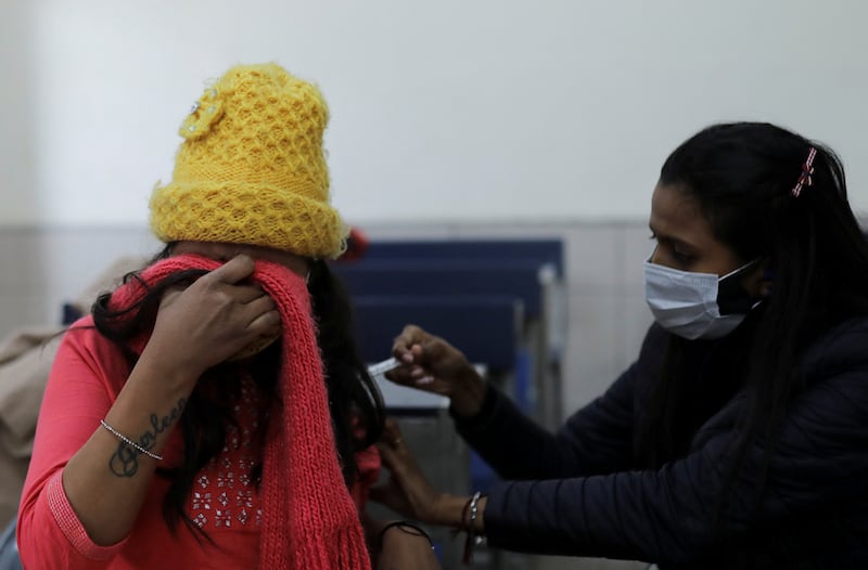 A woman receives a dose of the Covishield vaccine against the coronavirus at a centre in New Delhi, India. Reuters