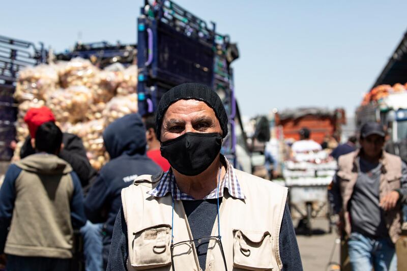 vendor poses for a photograph at the Amman Central fruits and vegetable market, in Amman, Jordan, on April 8, 2020. EPA