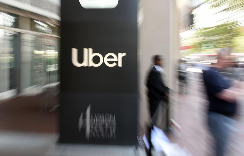 (FILES) In this file pan zoom image, an Uber logo is seen outside the company's headquarters in San Francisco, California on May 8, 2019.  Uber said May 6, 2020 it was cutting 3,700 jobs amid a huge slump in its ride-hailing operations during the pandemic.The cuts amount to around 14 percent of Uber's global workforce, which does not include its contract drivers.The company made the announcement in a regulatory filing, which also said chief executive Dara Khosrowshahi would waive his base salary for the remainder of the year.
 / AFP / Josh Edelson

